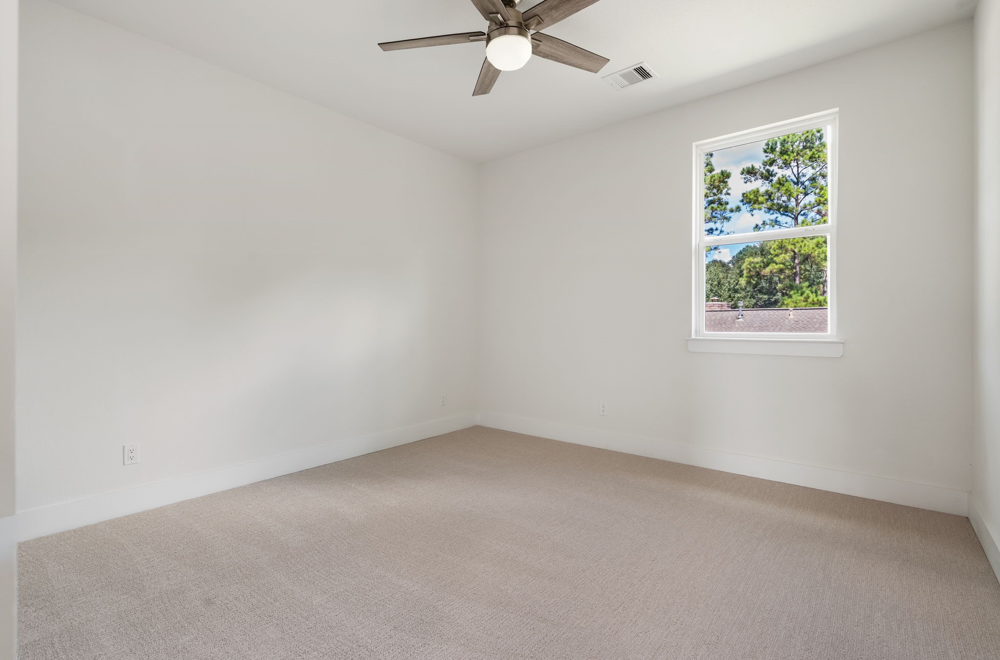 22806 August Leaf Drive Tomball, TX 77375 - Photo 23 of 34 an empty room with a window and a fan