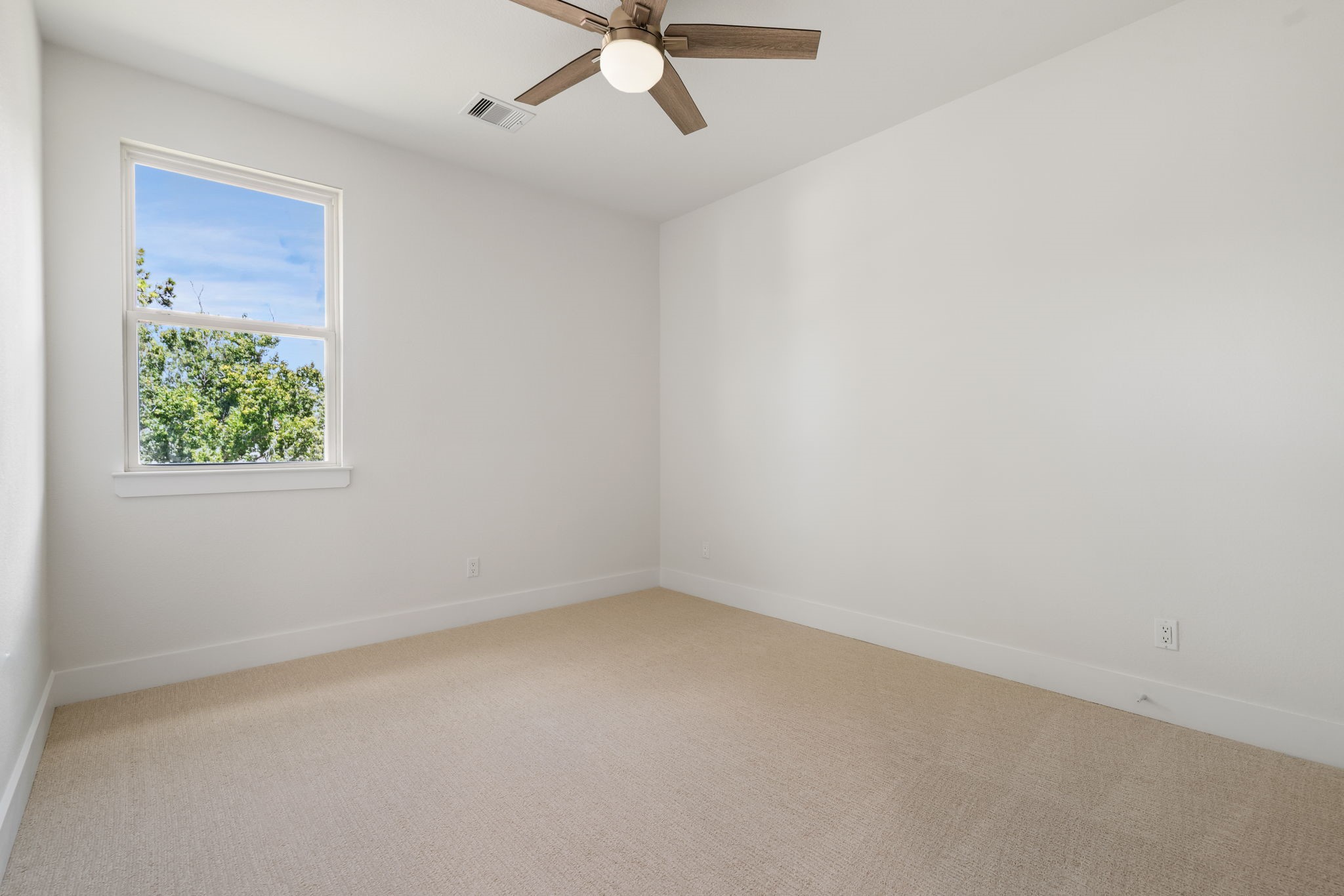 22806 August Leaf Drive Tomball, TX 77375 - Photo 24 of 34 an empty room with a window and a ceiling fan