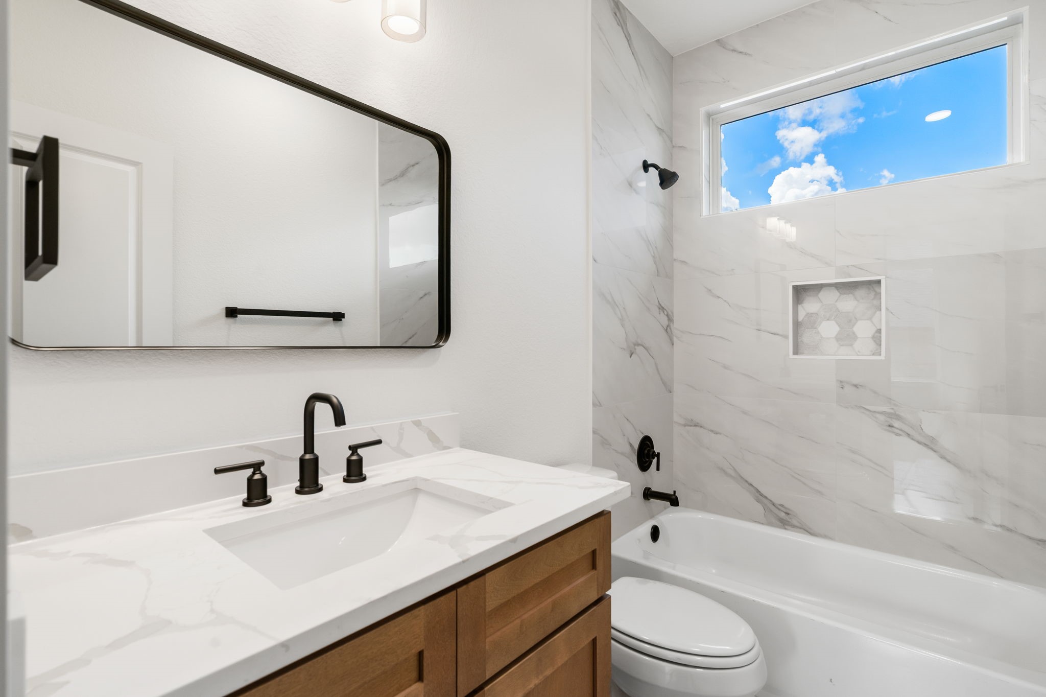 22806 August Leaf Drive Tomball, TX 77375 - Photo 25 of 34 a bathroom with a sink a toilet and bathtub