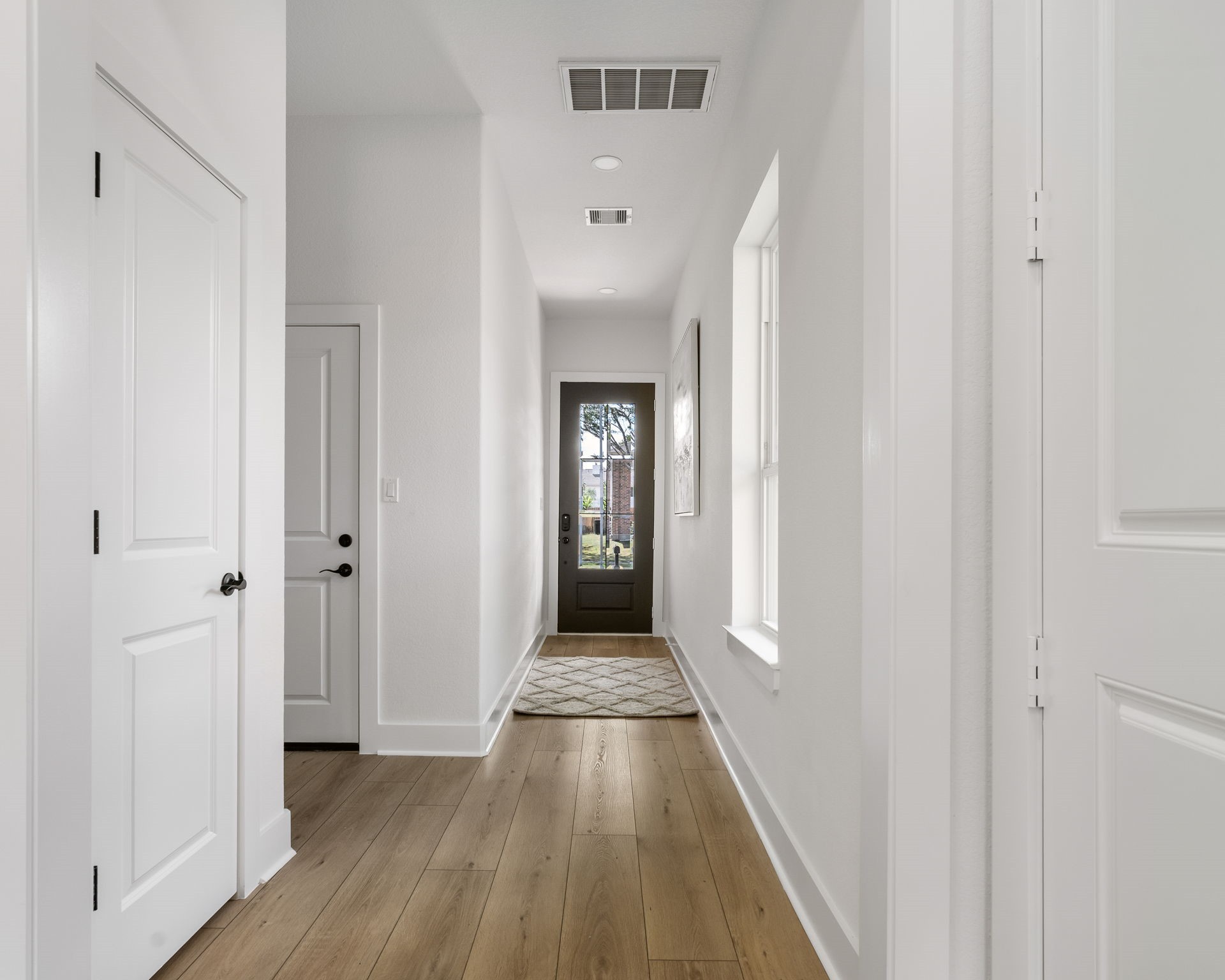 22806 August Leaf Drive Tomball, TX 77375 - Photo 3 of 34 a view of a hallway view with wooden floor and staircase