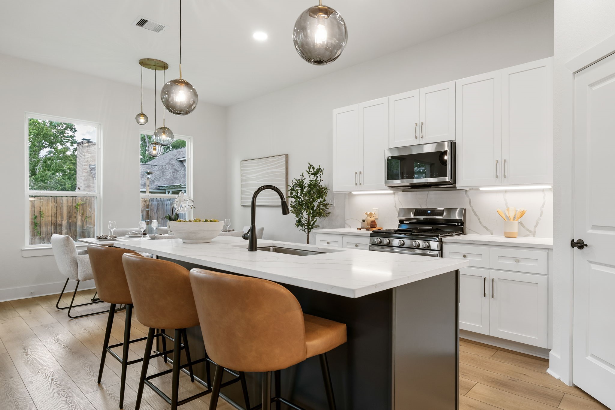 22806 August Leaf Drive Tomball, TX 77375 - Photo 9 of 34 a kitchen with appliances a sink and cabinets
