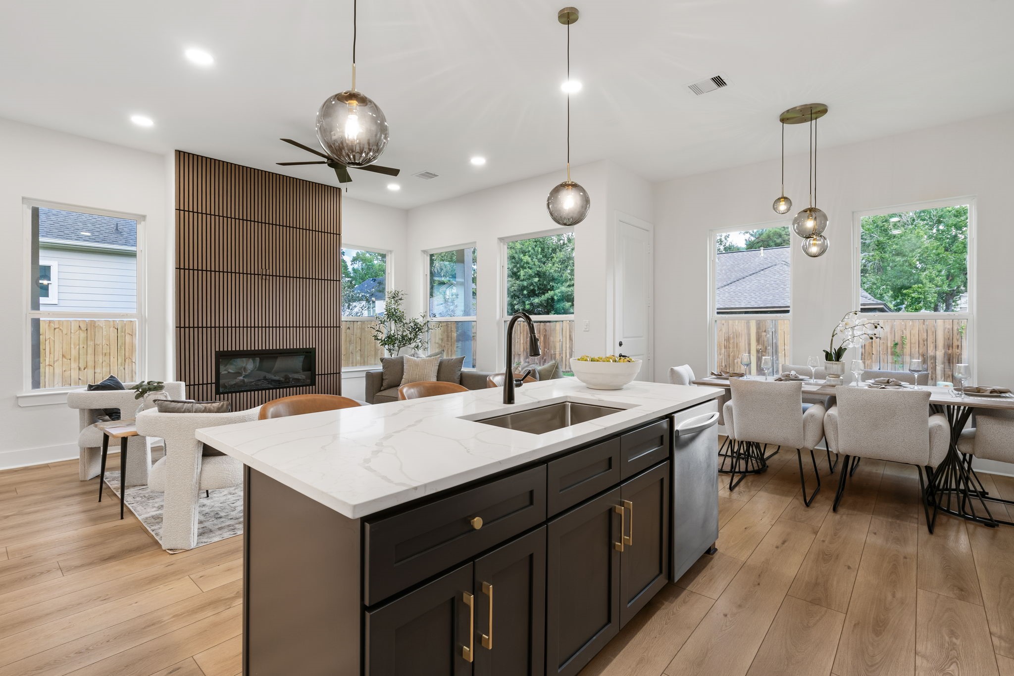 22806 August Leaf Drive Tomball, TX 77375 - Photo 10 of 34 a open kitchen with a sink a center island a dining table and chairs