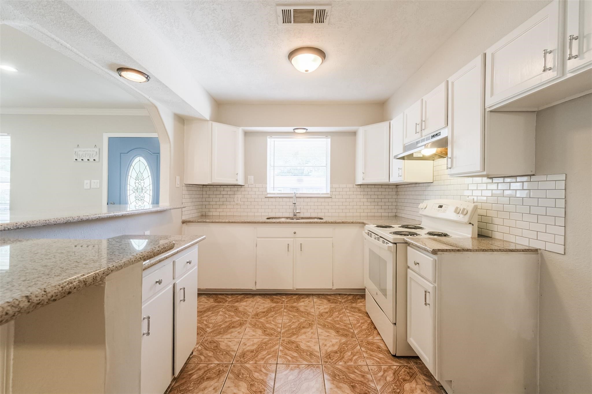 6751 Richwood Road Houston, TX 77087 - Photo 4 of 10 a kitchen with granite countertop a sink stove and cabinets