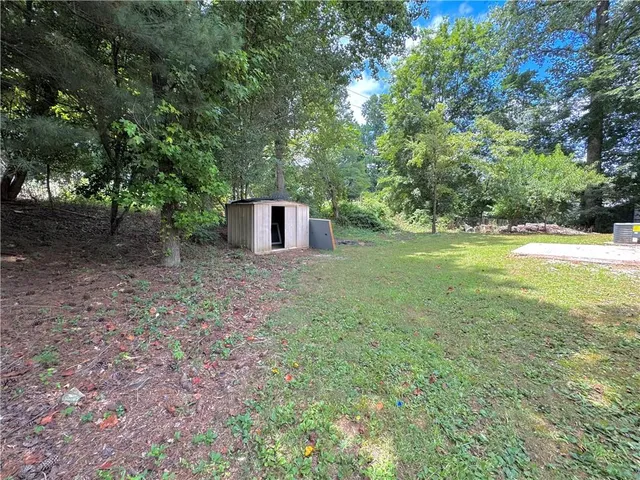 a view of a backyard with large trees