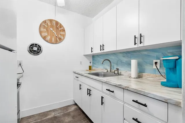 a kitchen with a stove and a white cabinet