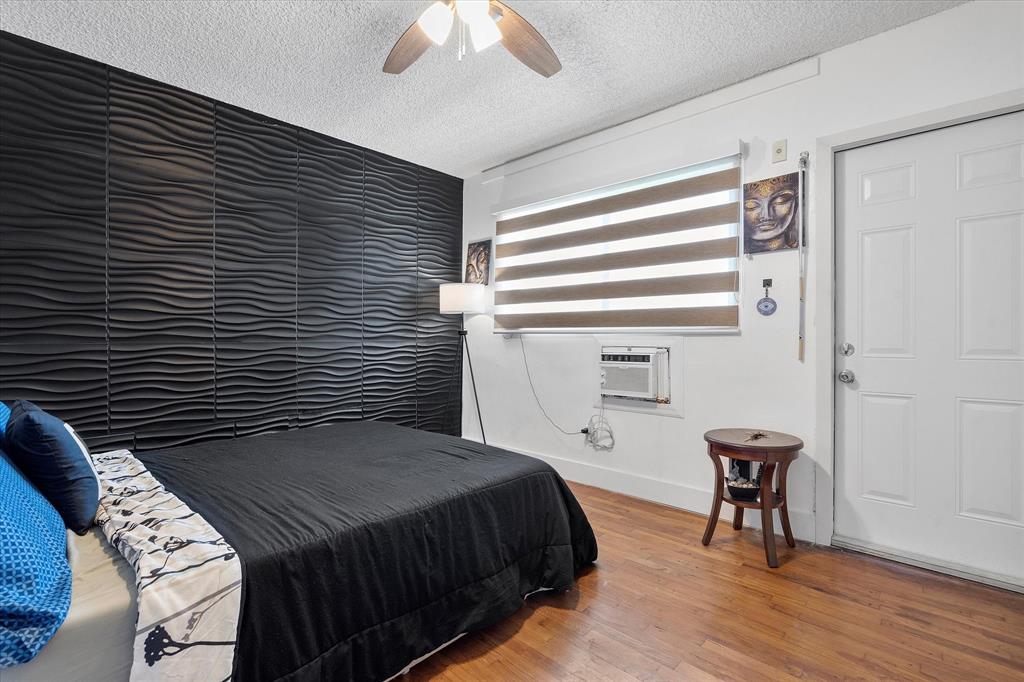 900 Atlantic Shores Boulevard, Unit 209 Hallandale Beach, FL 33009 - Photo 9 of 20 a bedroom with a bed and a chandelier