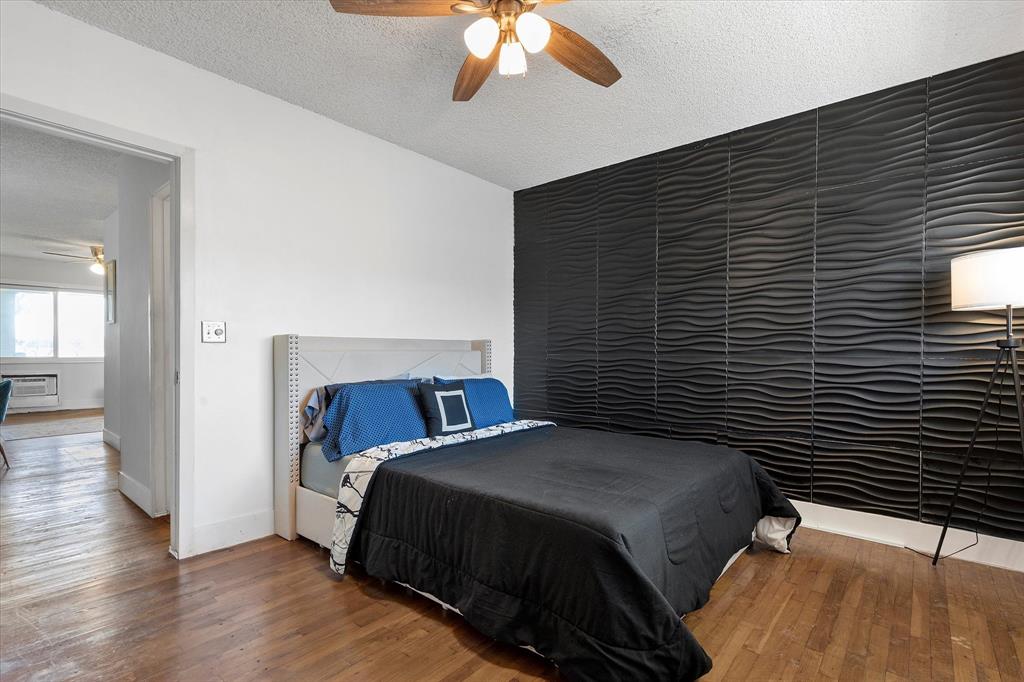 900 Atlantic Shores Boulevard, Unit 209 Hallandale Beach, FL 33009 - Photo 10 of 20 a bedroom with a bed and a chandelier