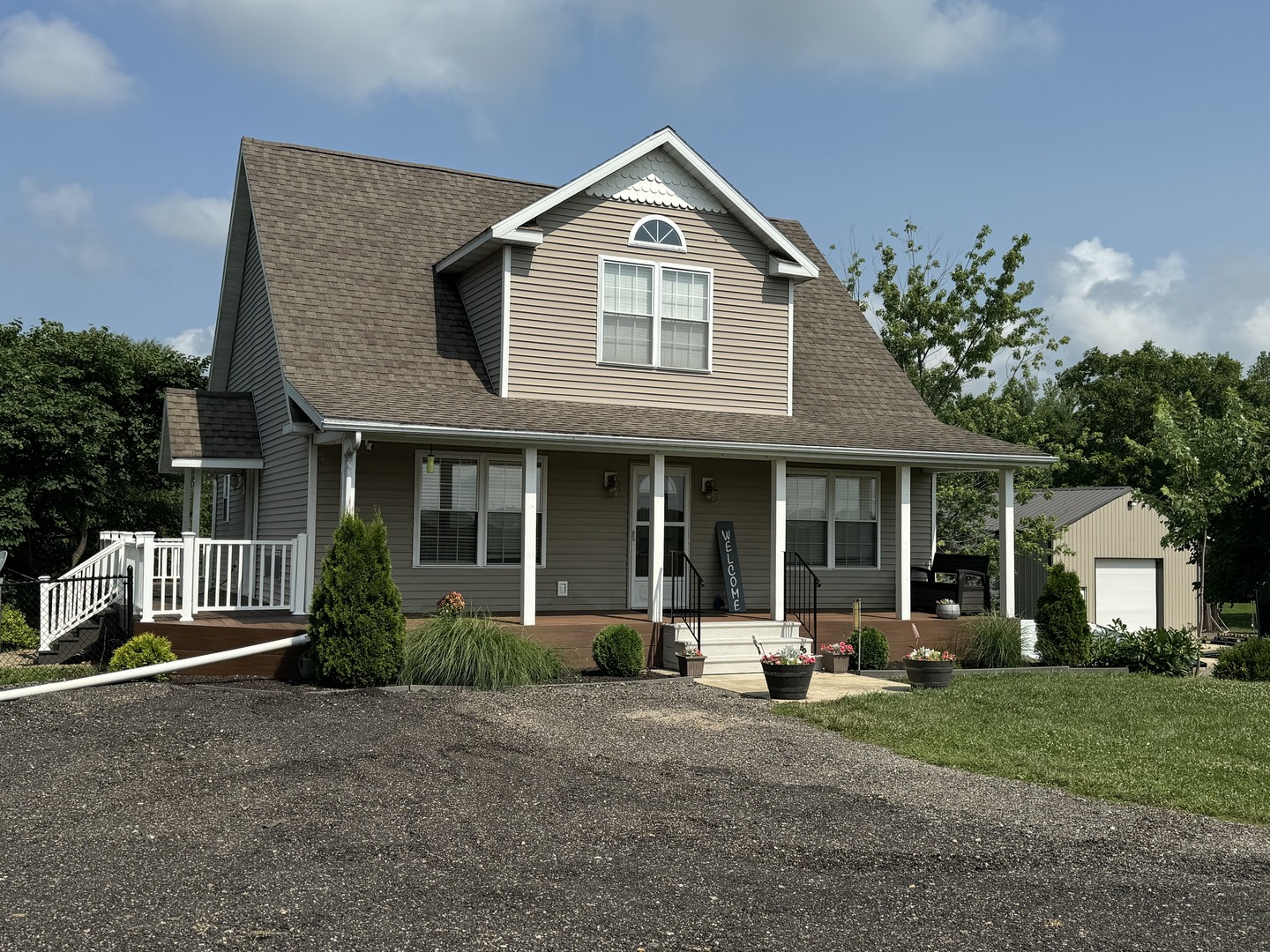 561 County Road 2000 East Secor, IL 61771 - Photo 1 of 37 a front view of a house with a yard and potted plants