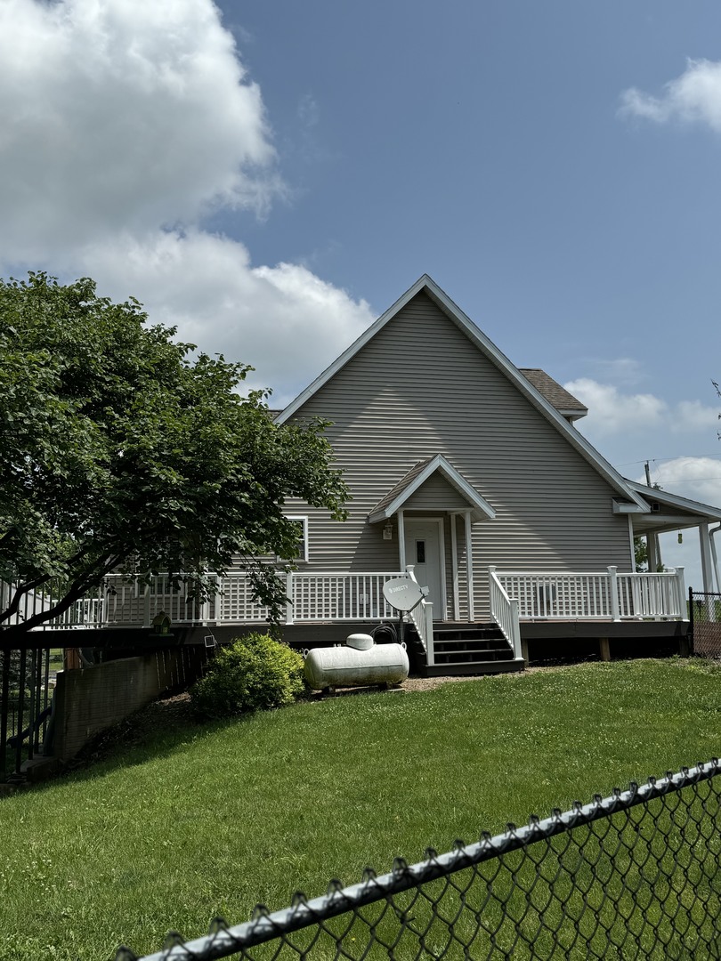 561 County Road 2000 East Secor, IL 61771 - Photo 11 of 37 a front view of a house with a garden