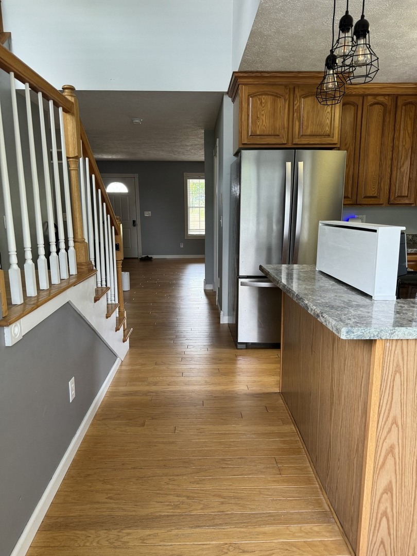561 County Road 2000 East Secor, IL 61771 - Photo 13 of 37 a view of a kitchen with a refrigerator and wooden floor