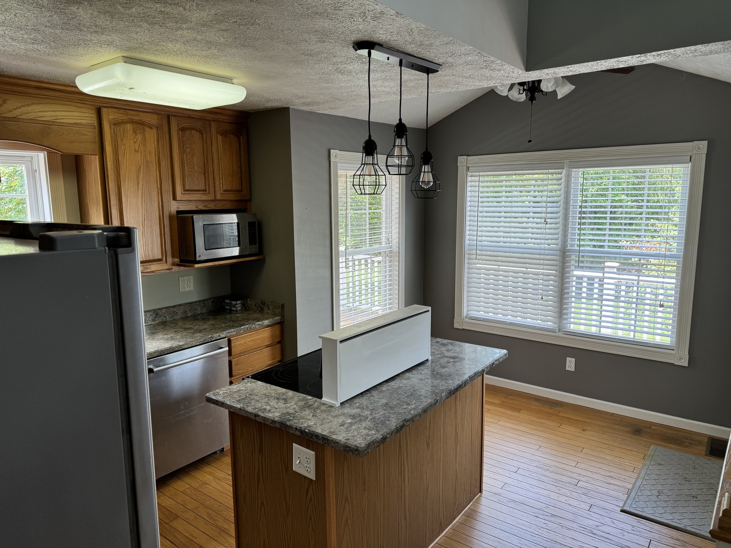 561 County Road 2000 East Secor, IL 61771 - Photo 15 of 37 a kitchen with stainless steel appliances granite countertop a refrigerator a sink dishwasher a oven and a dining table with wooden floor