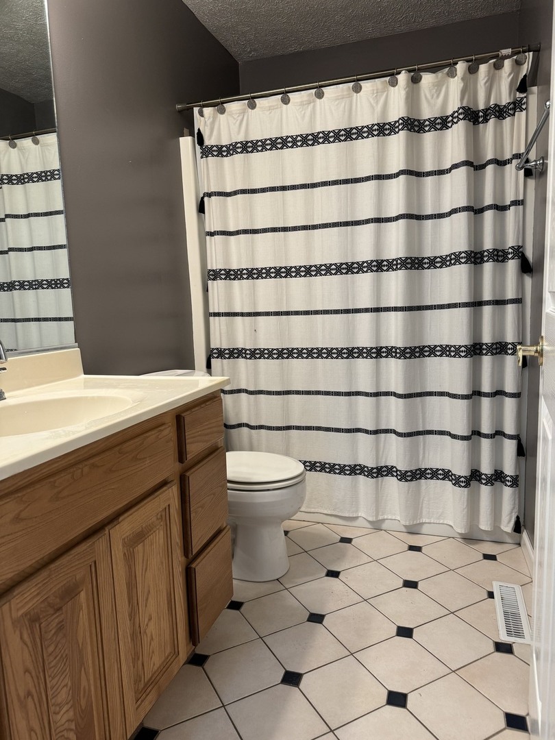 561 County Road 2000 East Secor, IL 61771 - Photo 16 of 37 a bathroom with a toilet and a shower curtain