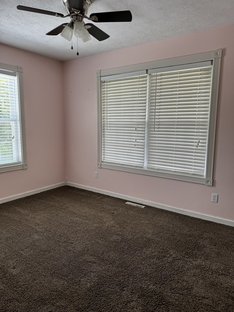 561 County Road 2000 East Secor, IL 61771 - Photo 18 of 37 an empty room with a window and a ceiling fan