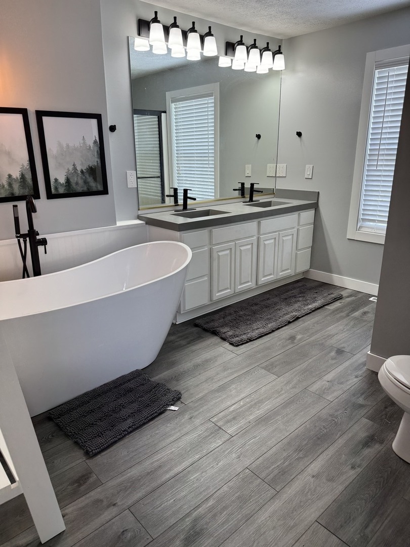 561 County Road 2000 East Secor, IL 61771 - Photo 20 of 37 a bathroom with a bathtub a double vanity sink and mirror