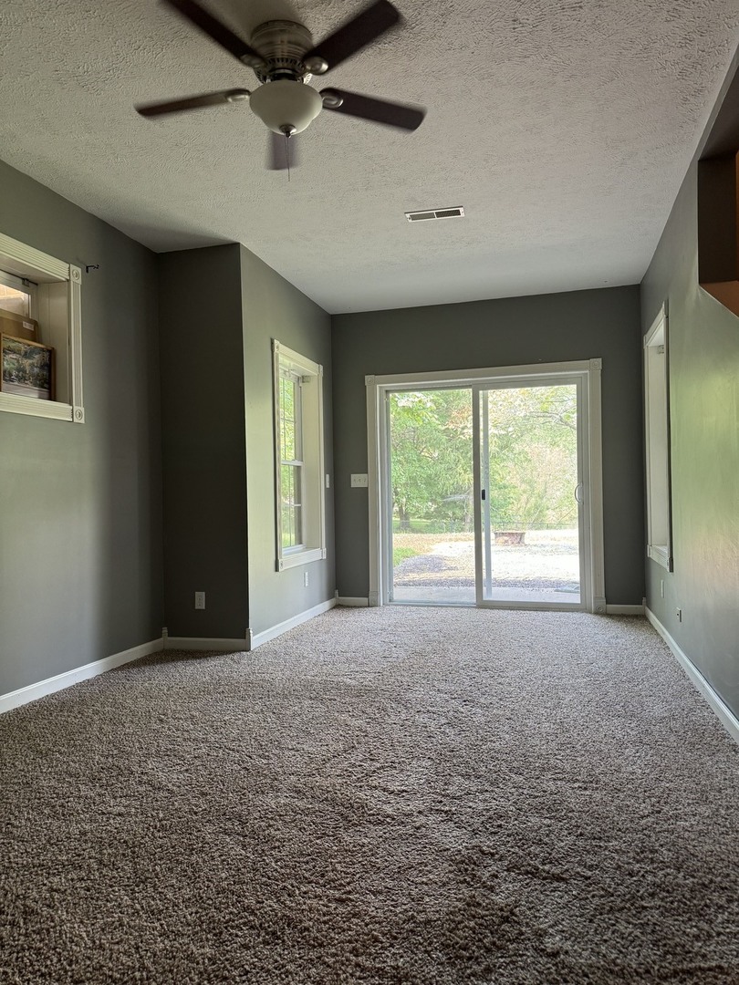 561 County Road 2000 East Secor, IL 61771 - Photo 23 of 37 a view of a big room with windows and chandelier fan
