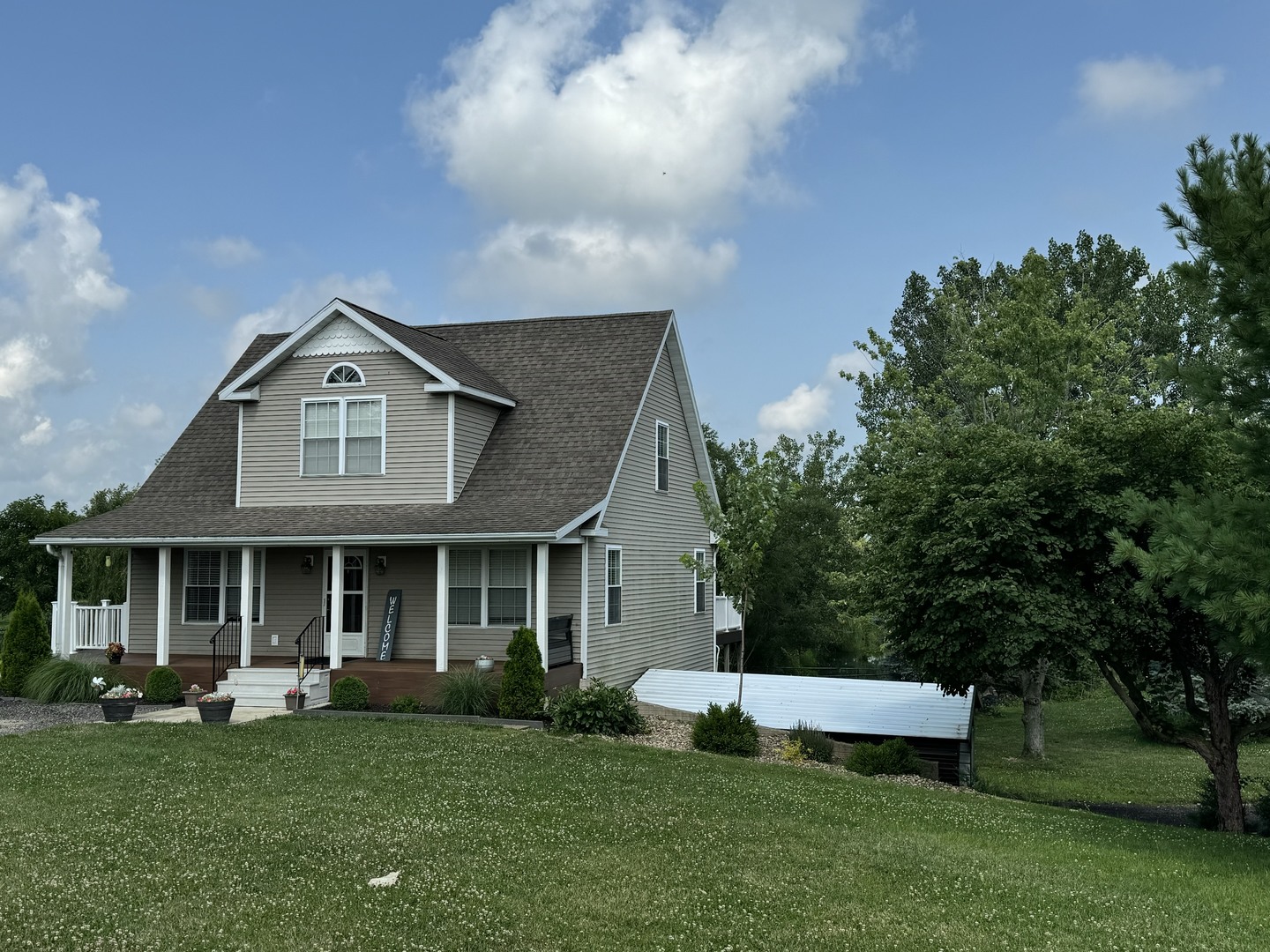 561 County Road 2000 East Secor, IL 61771 - Photo 8 of 37 a front view of a house with a garden and porch