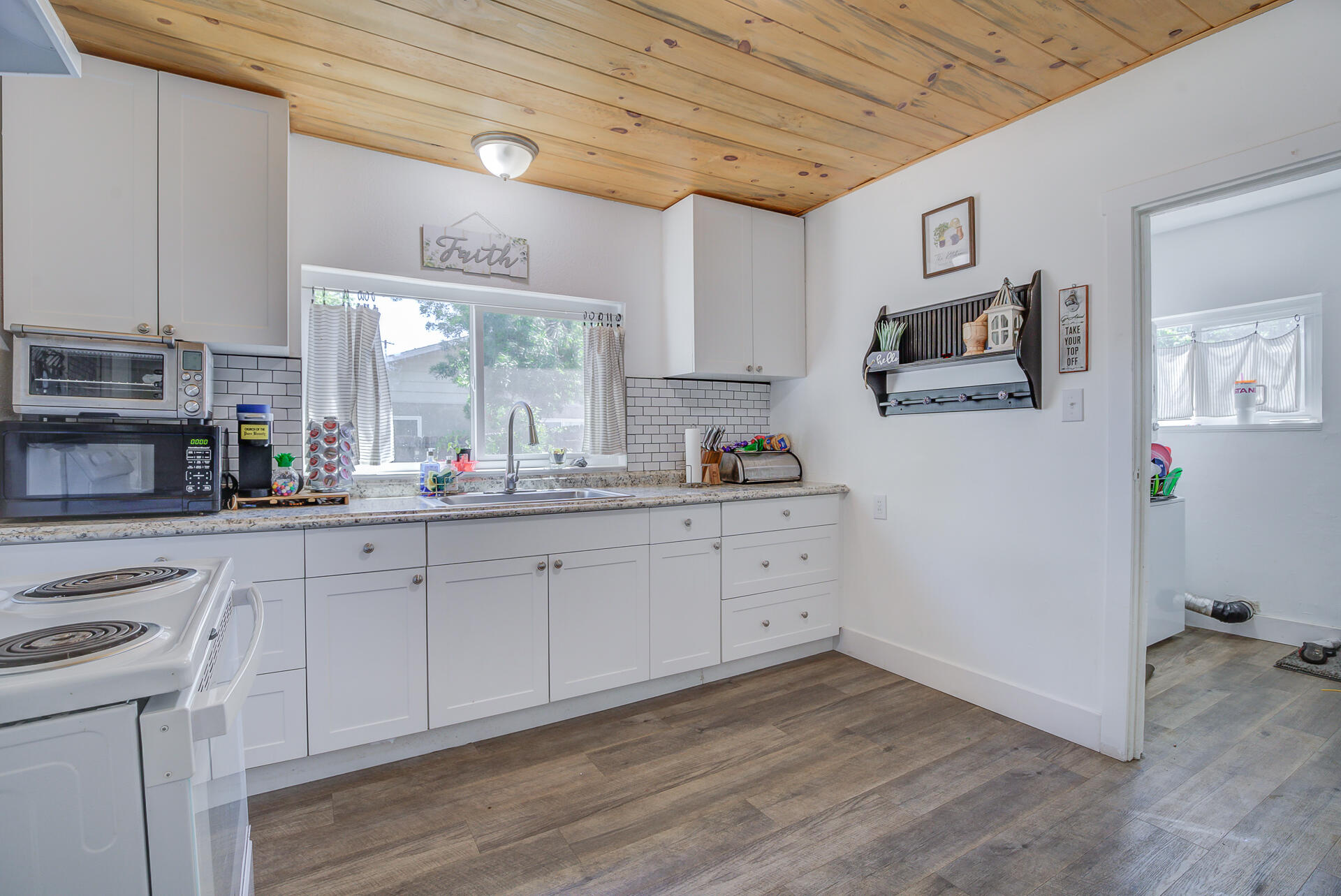 2962 Lanning Avenue Redding, CA 96001 - Photo 9 of 38 a kitchen with granite countertop white cabinets and white appliances