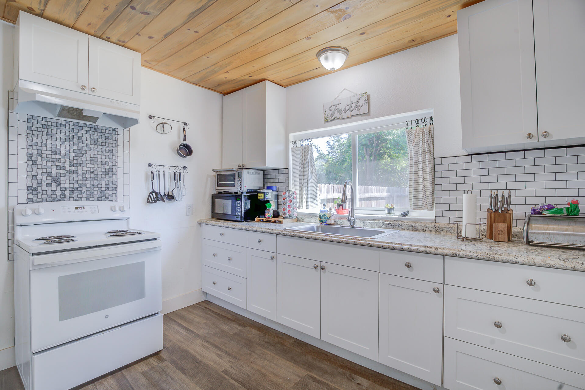 2962 Lanning Avenue Redding, CA 96001 - Photo 10 of 38 a kitchen with granite countertop white cabinets and white appliances