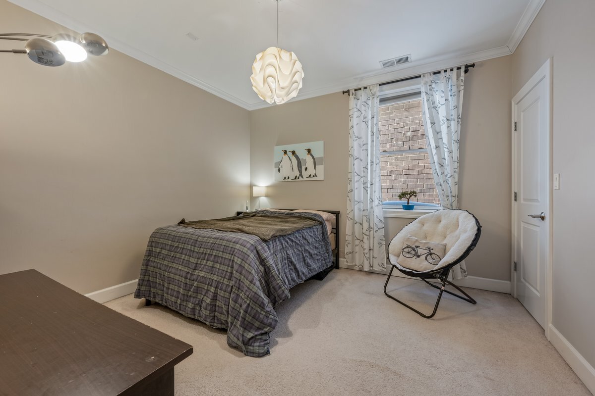 1025 West Monroe Street, Unit 3W Chicago, IL 60607 - Photo 13 of 19 a bedroom with a bed and chandelier