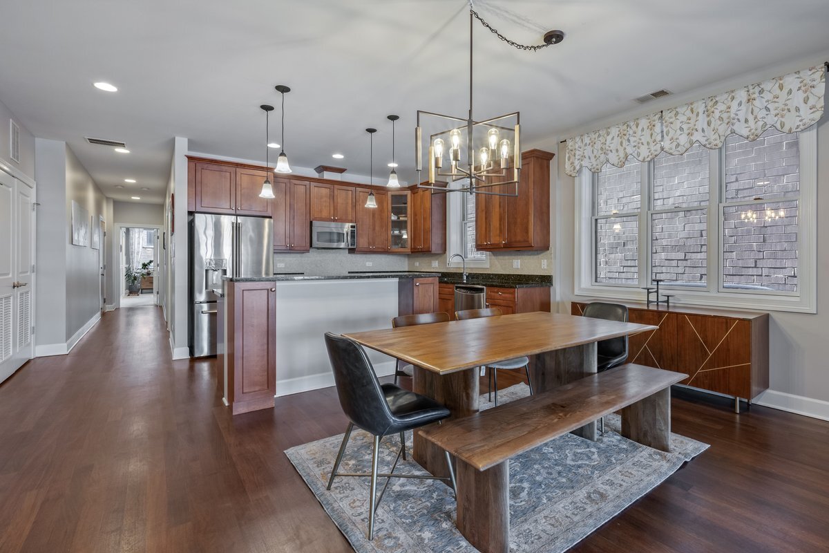 1025 West Monroe Street, Unit 3W Chicago, IL 60607 - Photo 7 of 19 a view of a dining room and livingroom with furniture wooden floor a chandelier