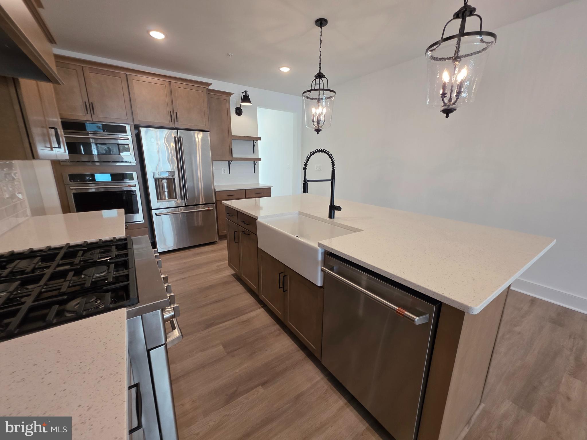 4817 Grandiflora Circle Perry Hall, MD 21128 - Photo 11 of 35 a kitchen with stainless steel appliances a refrigerator a sink a stove a microwave and island