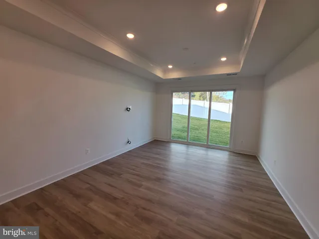 an empty room with wooden floor and sliding door