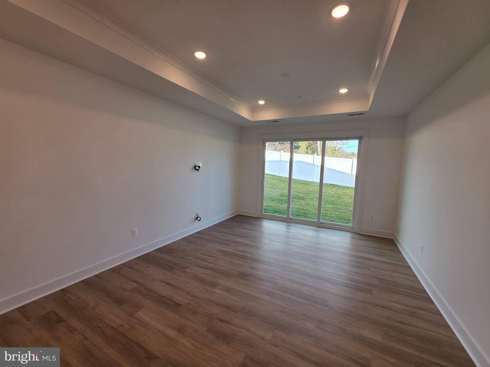 4817 Grandiflora Circle Perry Hall, MD 21128 - Photo 18 of 35 an empty room with wooden floor and sliding door