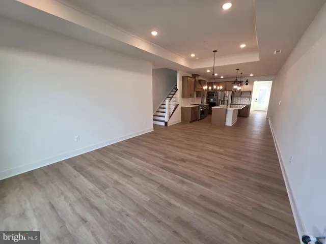 a view of a room with wooden floor
