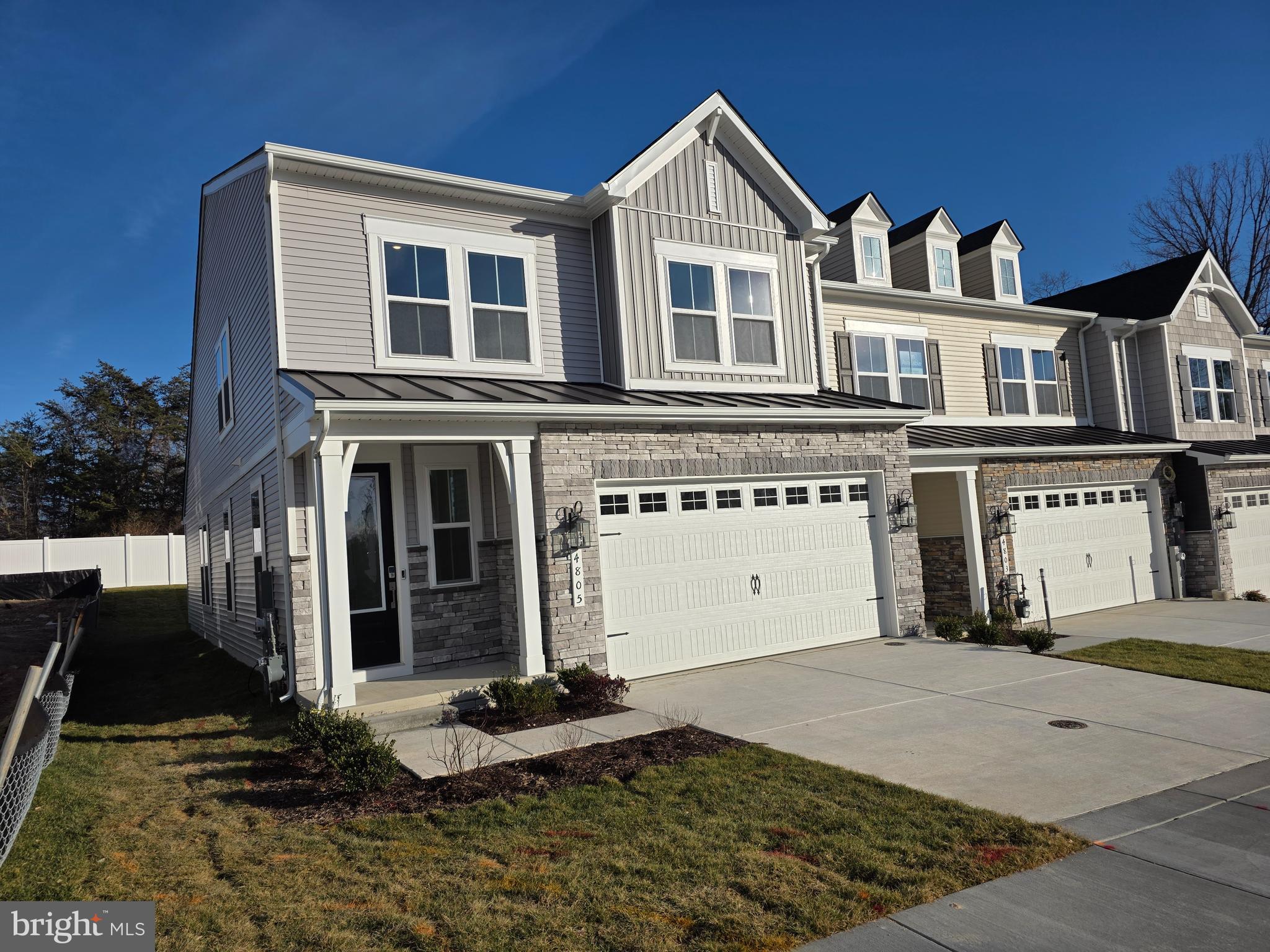 4817 Grandiflora Circle Perry Hall, MD 21128 - Photo 2 of 35 a view of a white house with large windows next to a yard