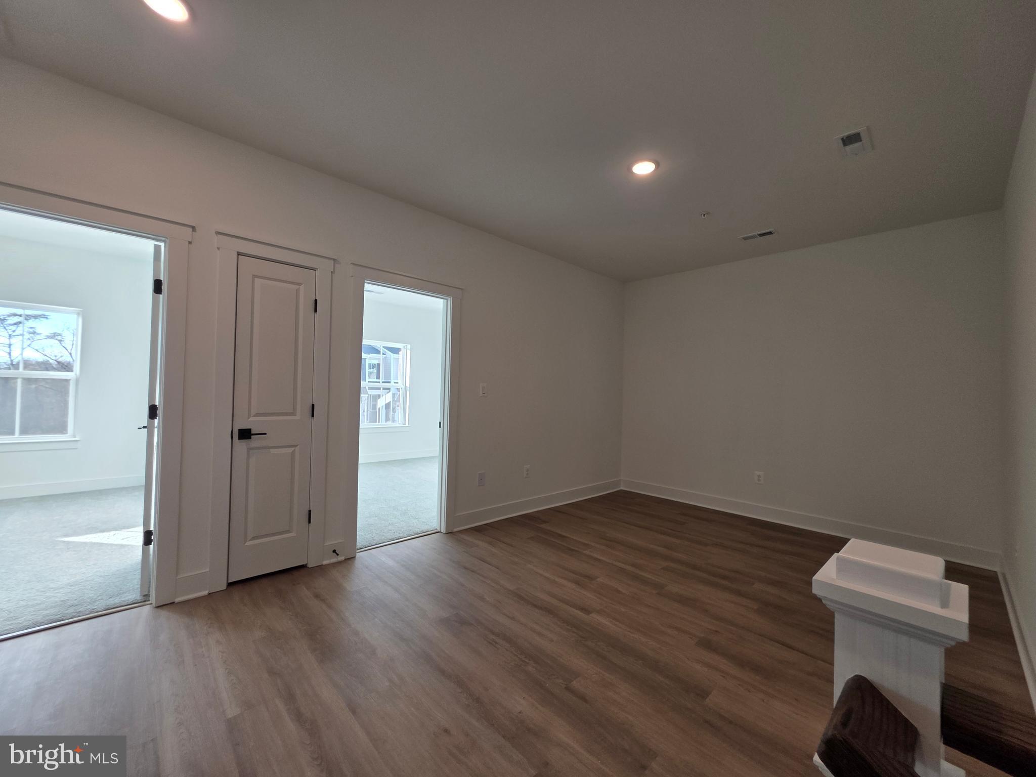 4817 Grandiflora Circle Perry Hall, MD 21128 - Photo 28 of 35 an empty room with wooden floor and windows