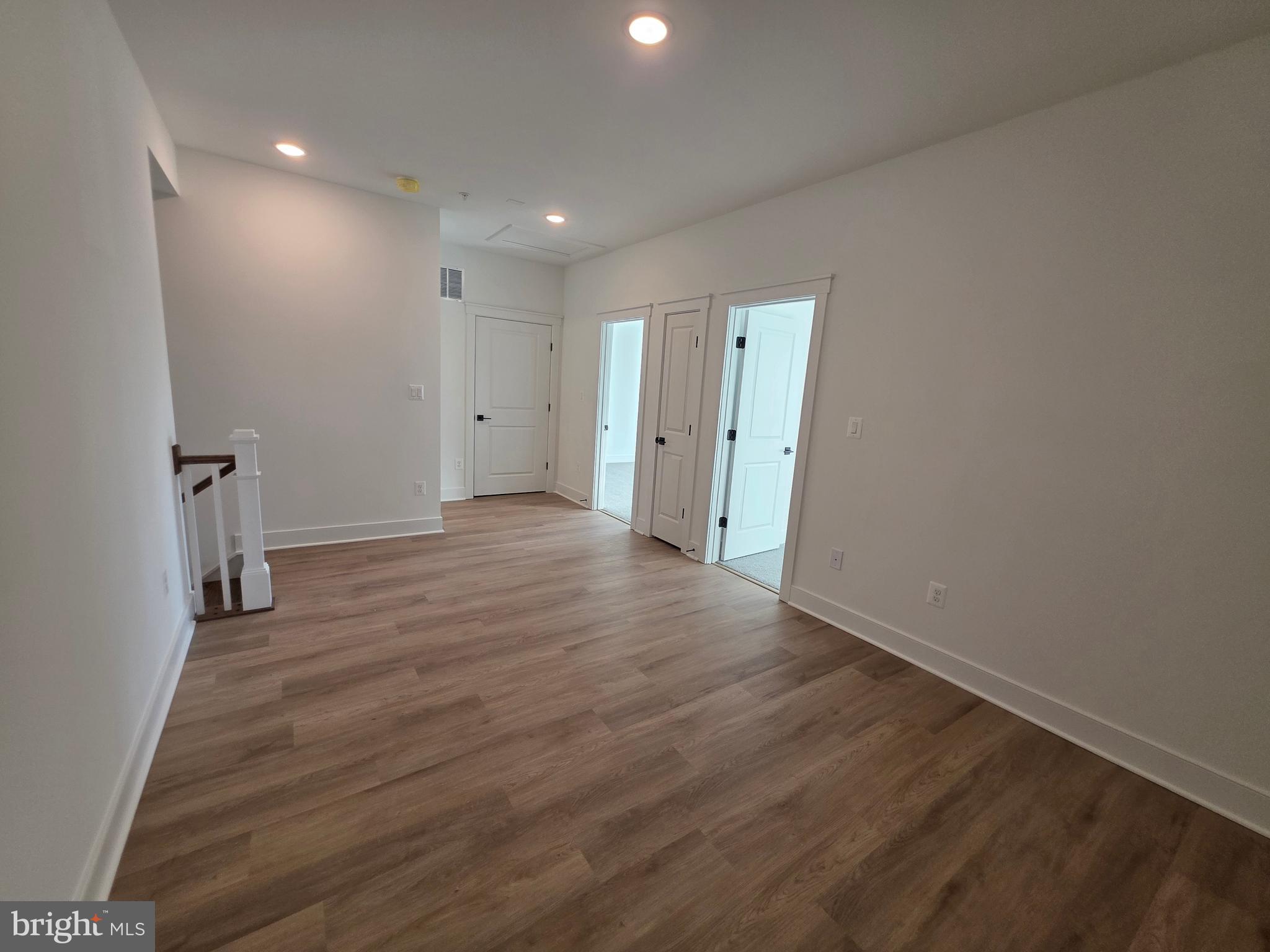 4817 Grandiflora Circle Perry Hall, MD 21128 - Photo 29 of 35 a view of an empty room with wooden floor