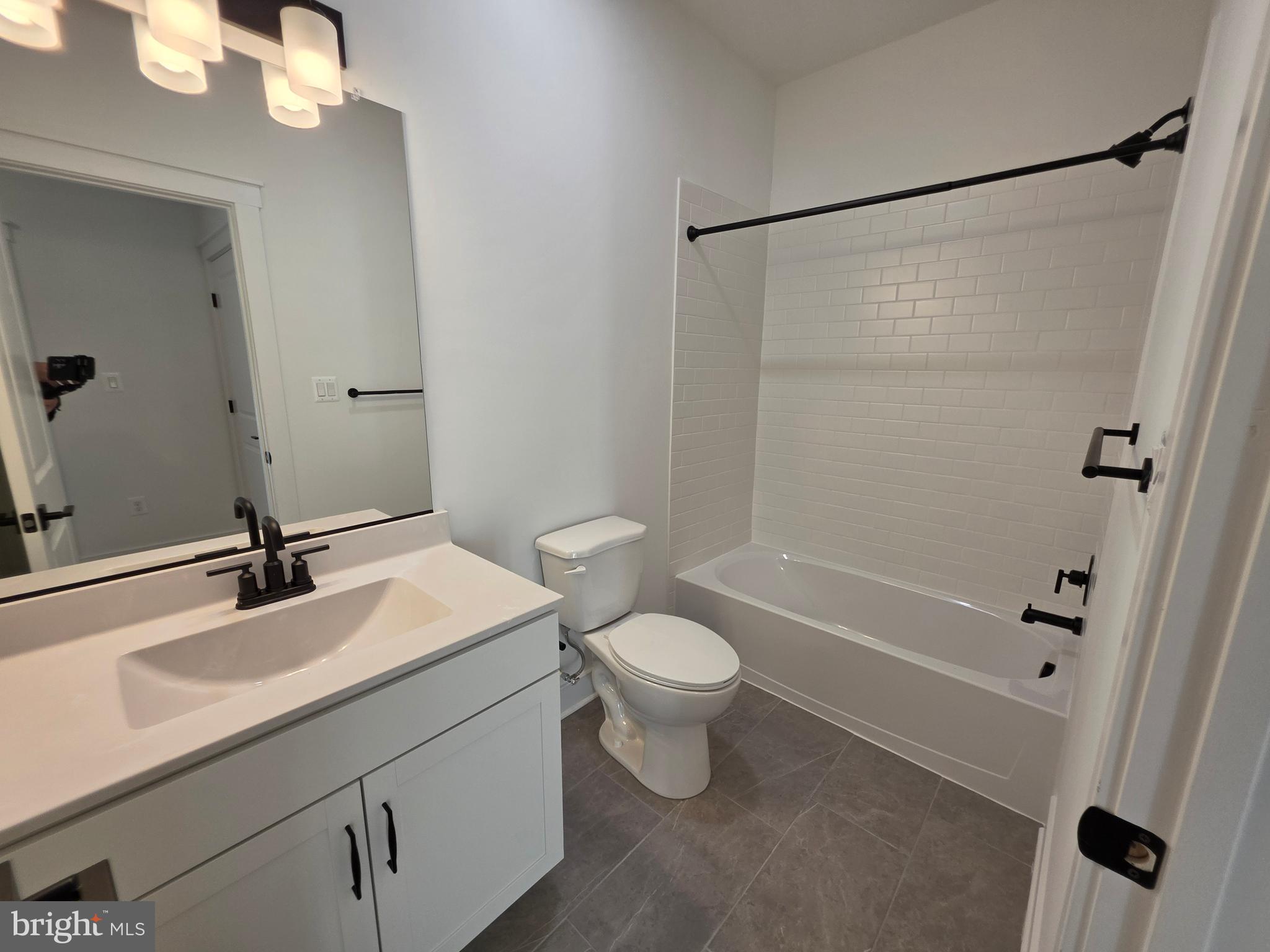 4817 Grandiflora Circle Perry Hall, MD 21128 - Photo 34 of 35 a bathroom with a sink a toilet and shower