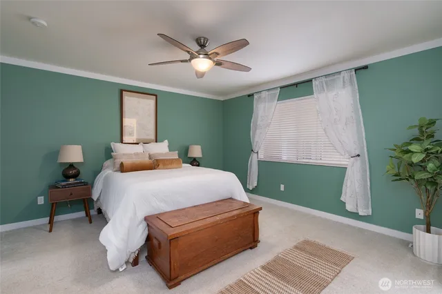 a bedroom with a bed and a potted plant