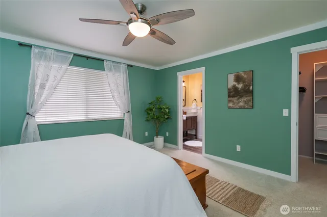 a bedroom with a large bed and a window