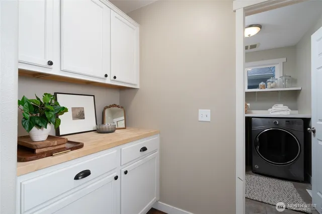 a kitchen with a sink and a stove with wooden floor