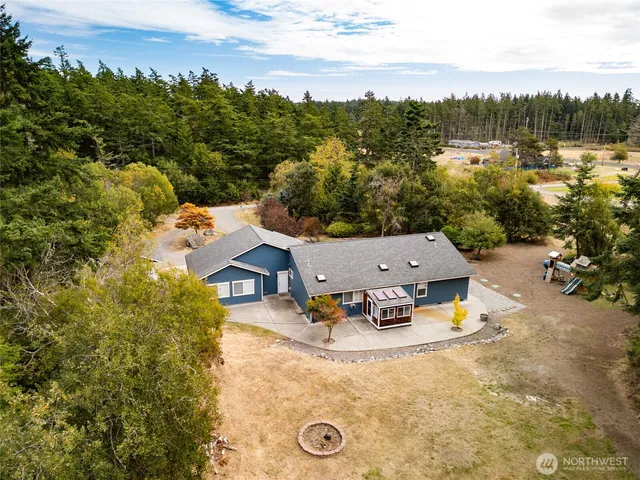an aerial view of residential houses with outdoor space and parking