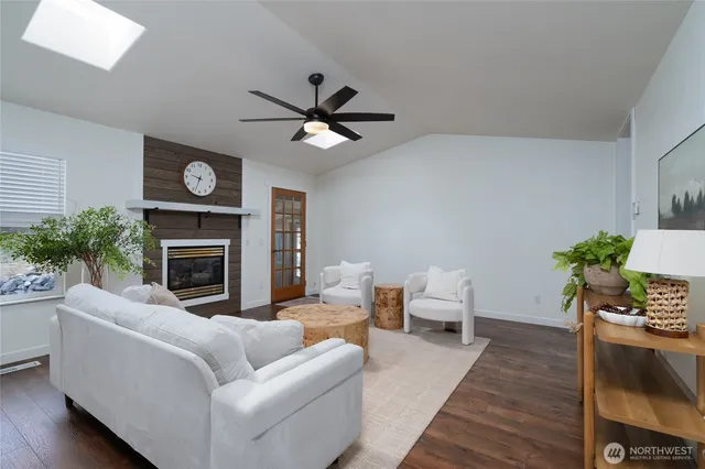 a living room with furniture a fireplace and a large window