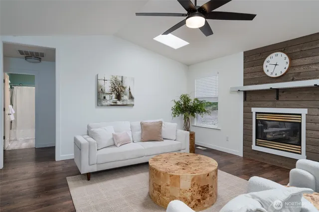 a living room with furniture a window and a fireplace