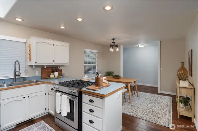 a kitchen with sink stove and cabinets