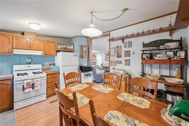 a large kitchen with a table and chairs