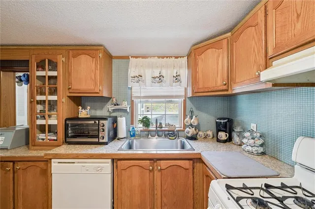 a kitchen with stainless steel appliances granite countertop a sink and cabinets
