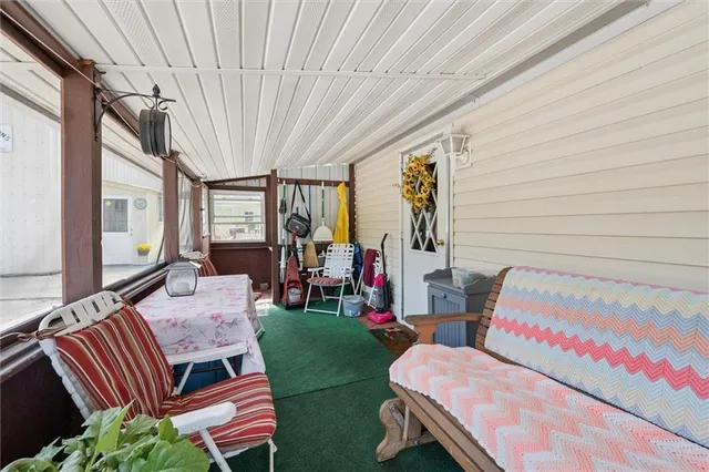 a view of a house with a yard and sitting area