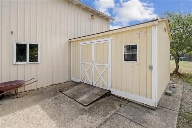 a room with gym equipment and a view of living room