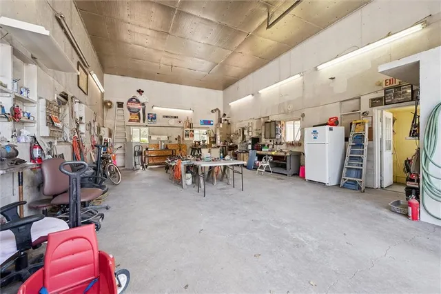 a view of a patio with table and chairs with wooden floor and fence