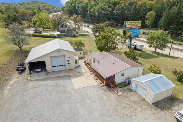 an aerial view of a house with a yard
