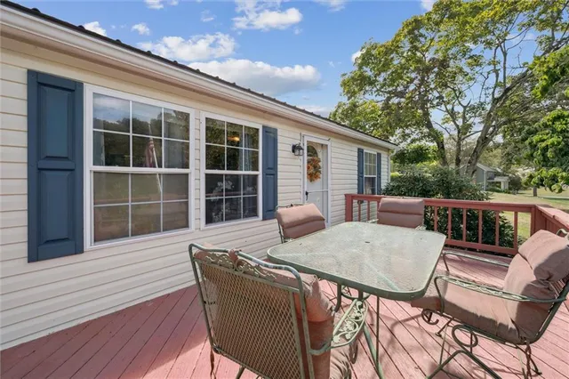 a view of a balcony with wooden floor and deck