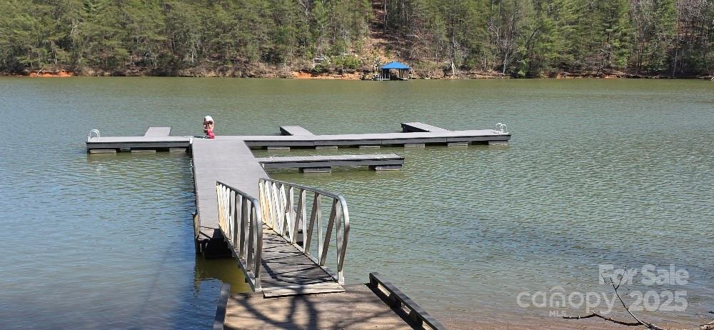 210 Ridge Top Drive Connelly Springs, NC 28612 - Photo 10 of 13 a view of a lake with chairs