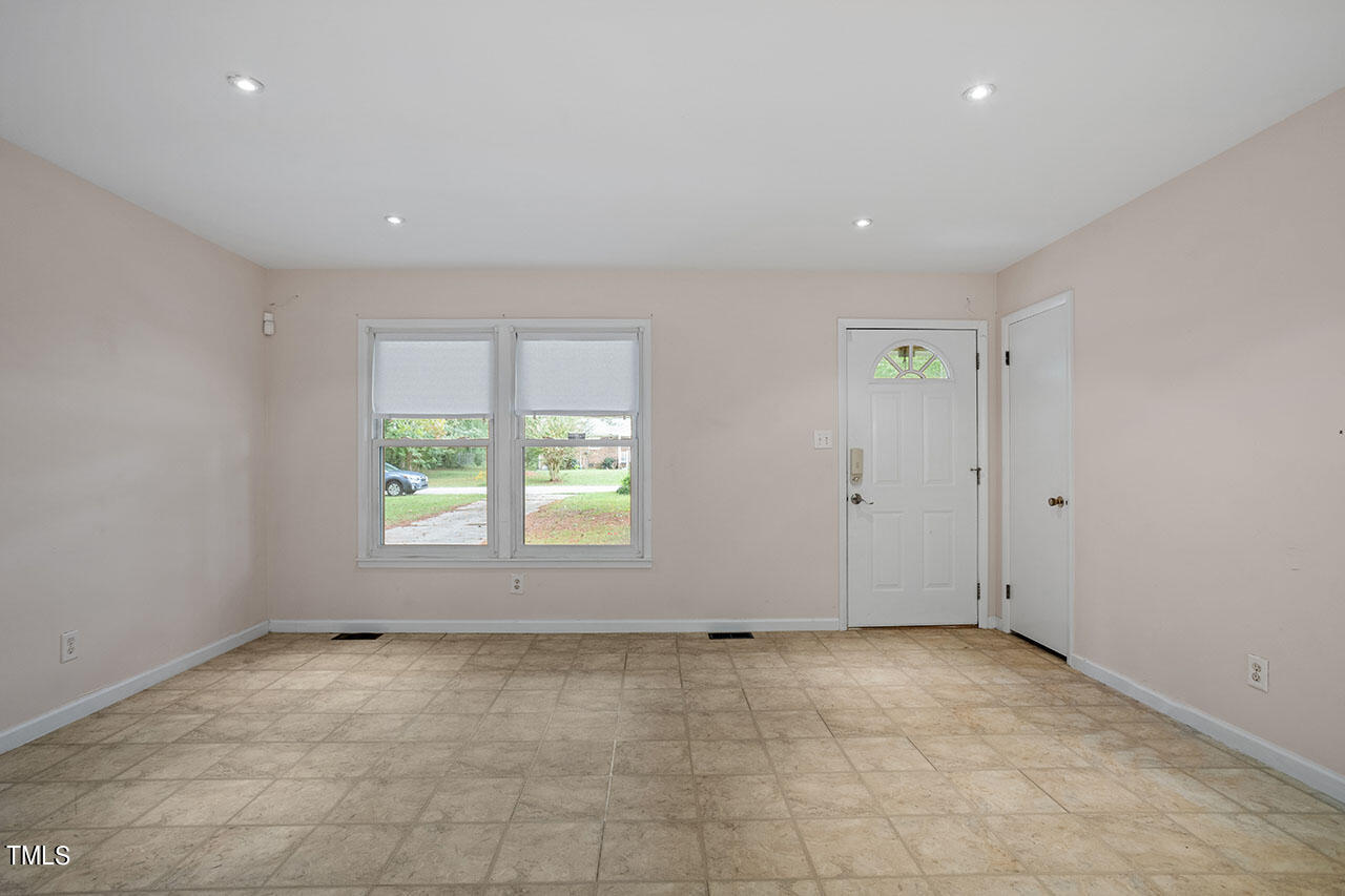 5808 Meadowbrook Road Raleigh, NC 27603 - Photo 7 of 18 a view of an empty room with a window