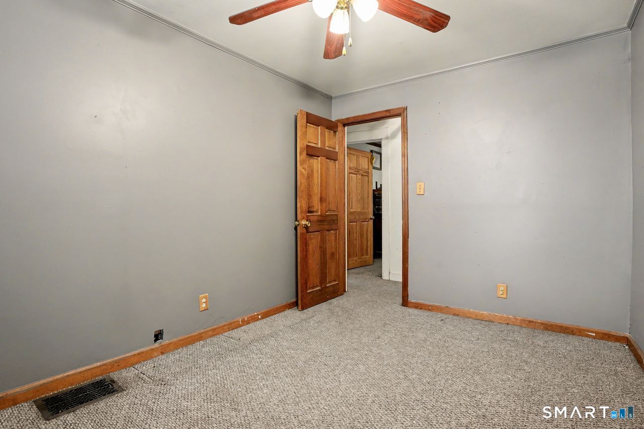 74 Maple Street Seymour, CT 06483 - Photo 30 of 40 an empty room with chandelier fan