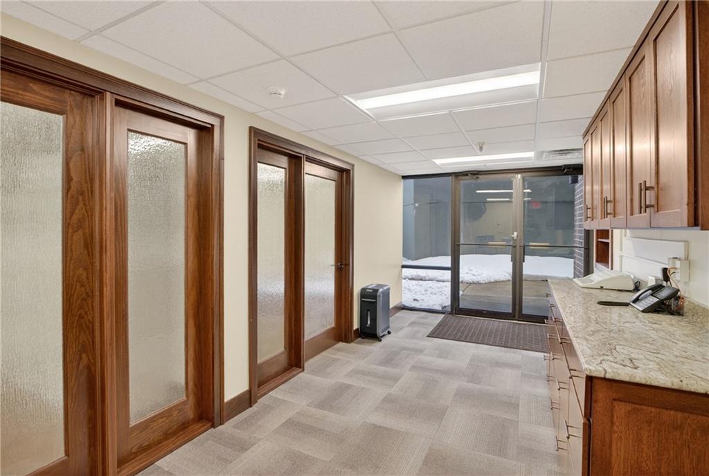 750 Washington Road Pittsburgh, PA 15228 - Photo 34 of 44 Right side workspace area with built in cabinets, granite counters, administrative work area with door to front office courtyard and offices 4 and 5 to the left.